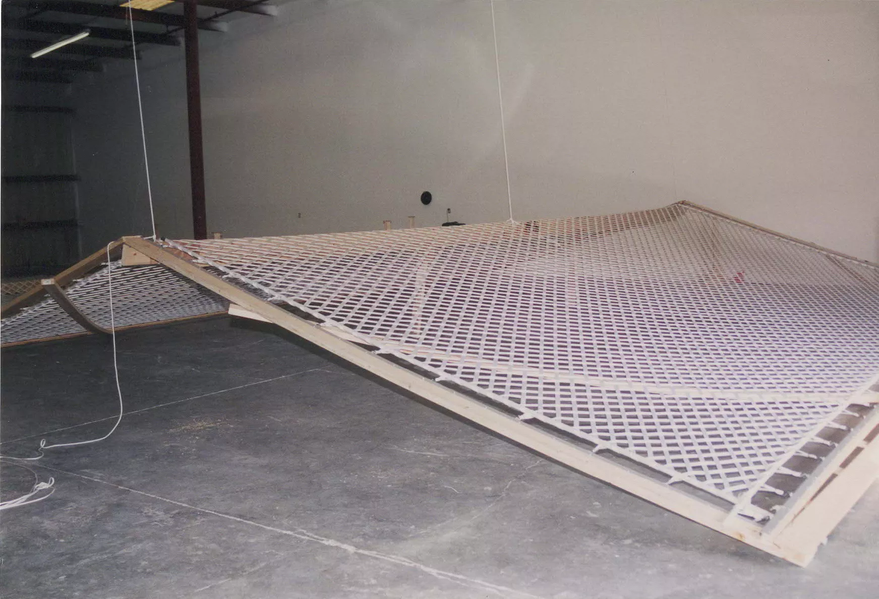 pic in warehouse with giant webbing net being folded