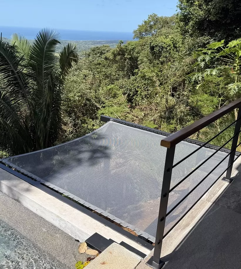 picture of net built into deck beside forest