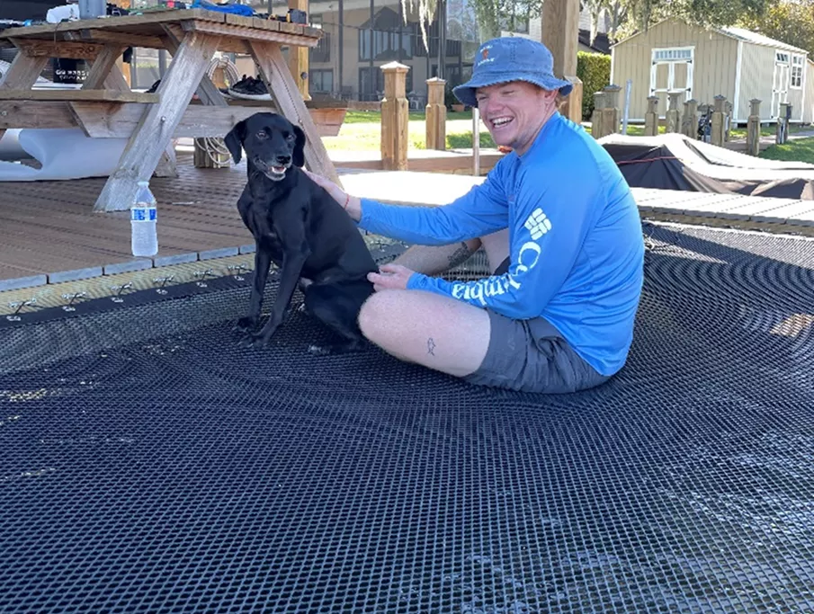 a kid and a dog enjoying an architectural net