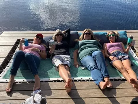 4 ladies relaxing on a tensioned net