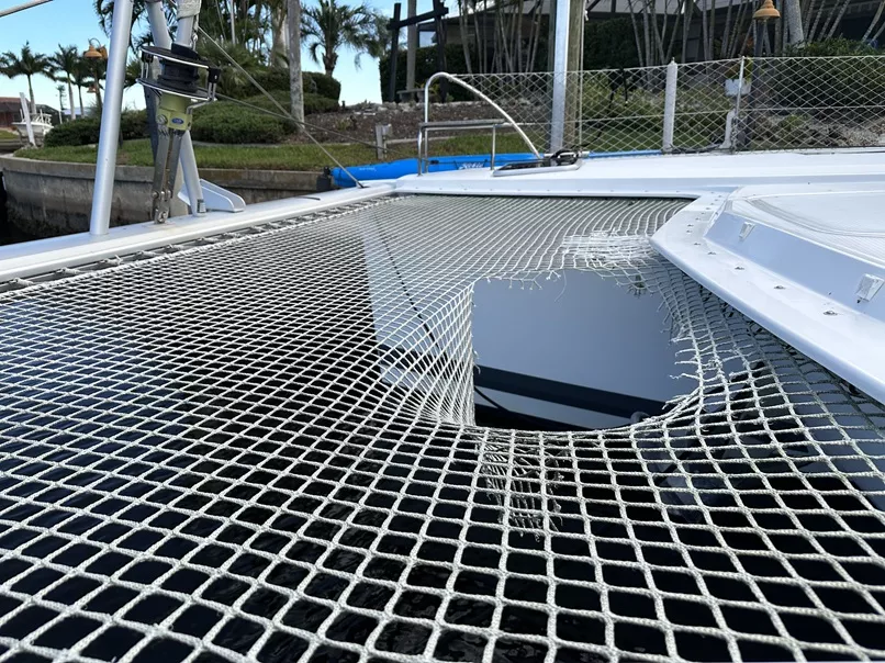 Picture of catamaran net someone almost fell through. Example of bad complete net failure.