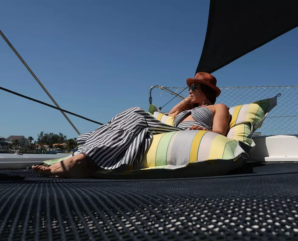 Sunrise Sailor's Pillow with a lady relaxing on a yacht