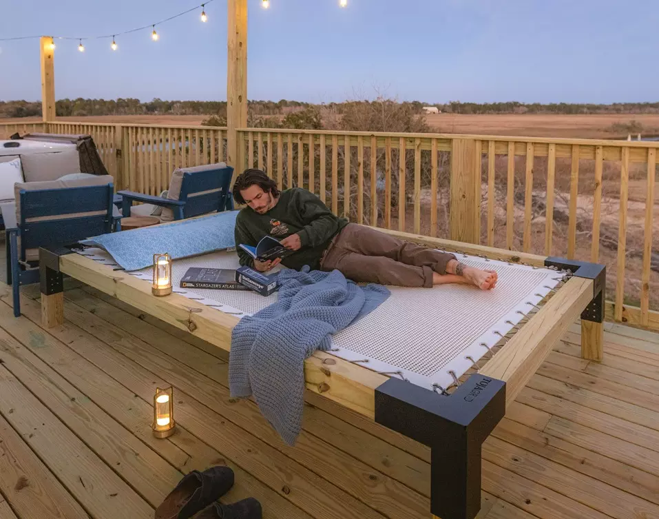 Sunrise Sailor's Pillow with man relaxing on Stargazer Daybed
