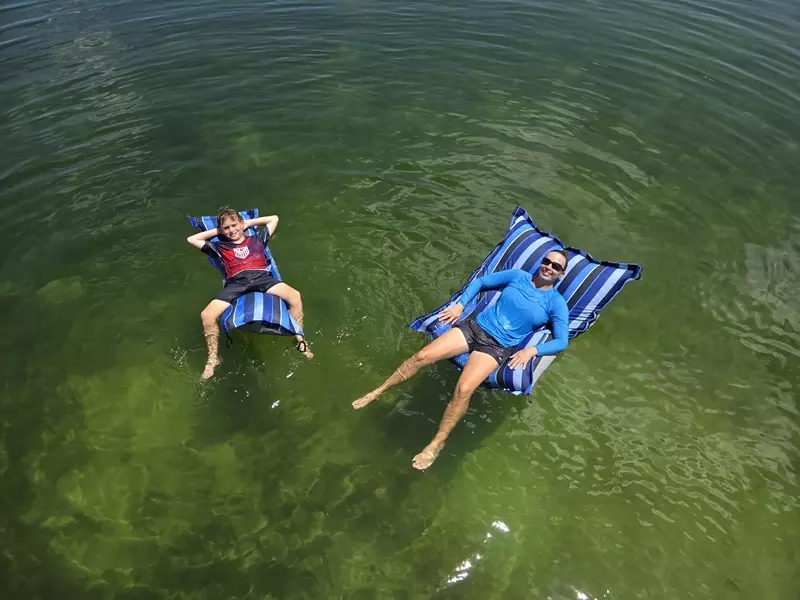 People relaxing on floating Sailor's Pillow
