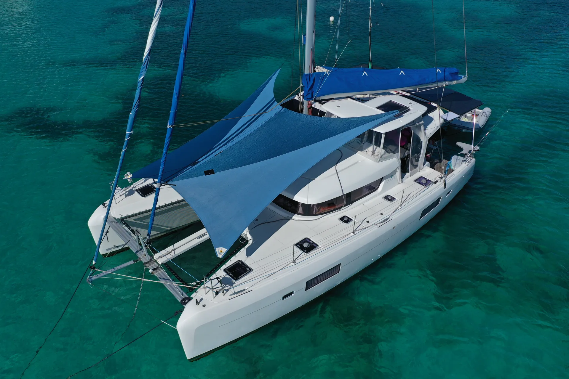 Aerial view of a multi-colored light and dark blue Sunrise SHADE on a Lagoon 42